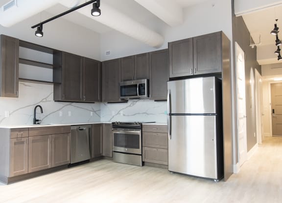 Kitchen with hardwood floors and stainless steel appliances at 35W in Detroit. MI