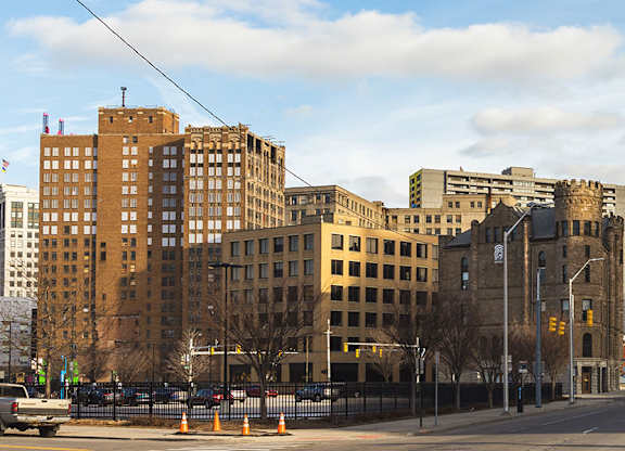 a view of a city street with tall buildings