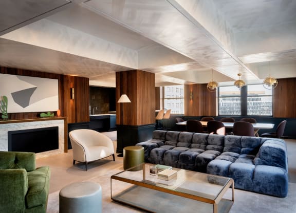 a shared amenity living room with a blue couch and a coffee tableat Book Tower, Detroit, MI, 48226