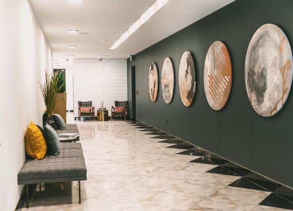Interior hallway with modern furnishings and elegant artwork at The May.
