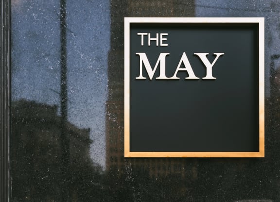The May, exterior signage in gold.