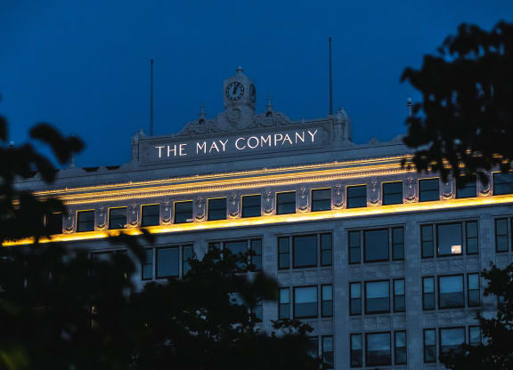 Exterior signage at The May at night.