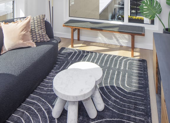a living room with a couch and a coffee table and a view of the city at The Weidler in Portland, OR 97209