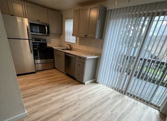 an empty kitchen with a sliding glass door