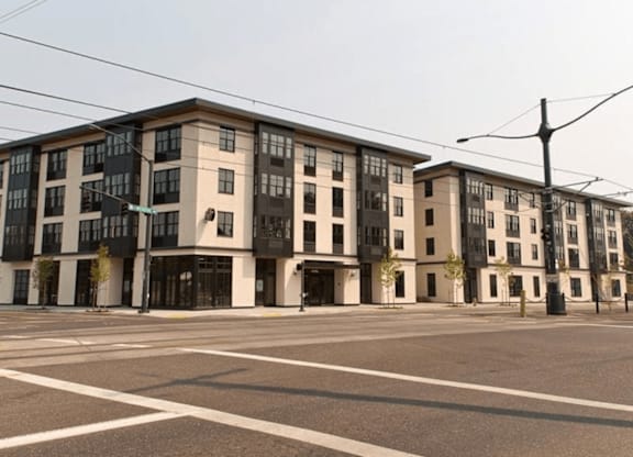 A large building with a lot of windows is in the background.