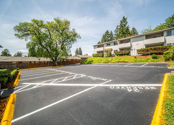 A parking lot with a yellow line and a sign that says
