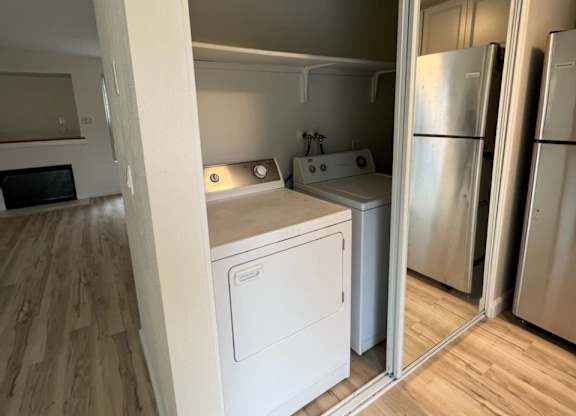 an empty room with a washer and dryer in it