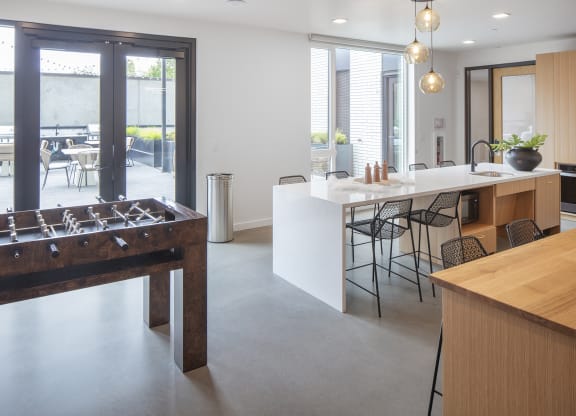 a foosball table in the center of a kitchen with a bar and a at The Weidler in Portland, OR 97209