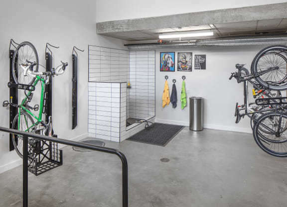 a room with bikes hanging on the wall and a bike rack in the corner at The Weidler in Portland, OR 97209