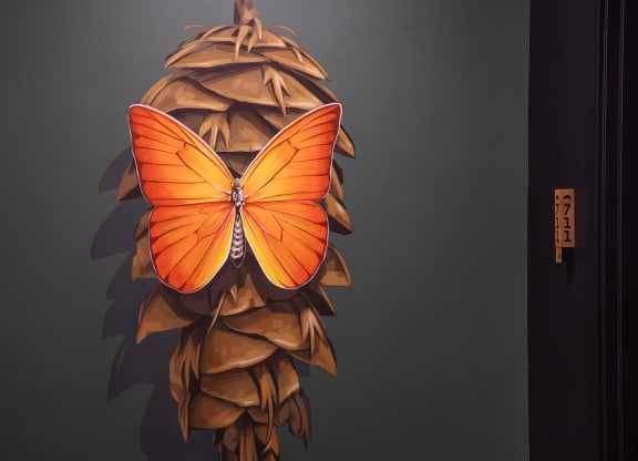 a butterfly shaped lamp on a wall next to a door at The Weidler in Portland, OR 97209