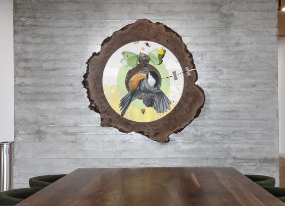 a wood wall with a bird on it and a wooden table at The Weidler in Portland, OR 97209