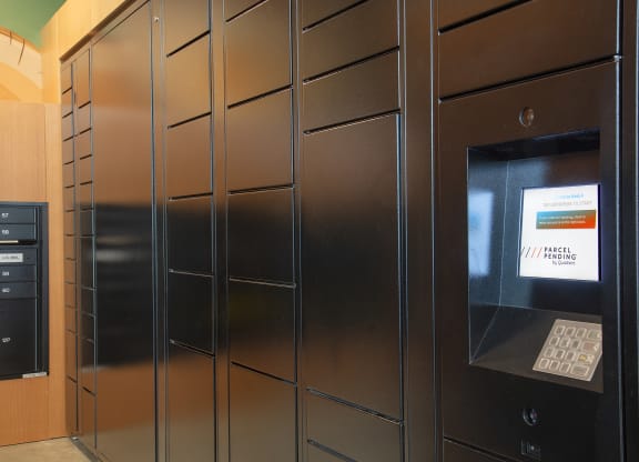 a set of stainless steel lockers with a bank teller machine in a lobby at The Weidler in Portland, OR 97209