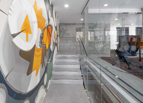 a staircase with a glass wall with a design on it at The Weidler in Portland, OR 97209