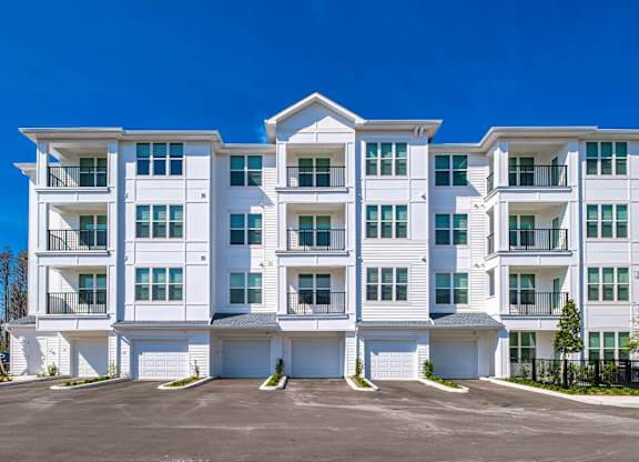 an image of an apartment building with a parking lot at Altis Twin Lakes Apartments, Kissimmee, Florida