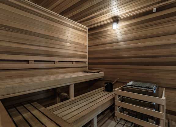 a sauna with wooden benches and a table at Altis Grand Suncoast, Florida