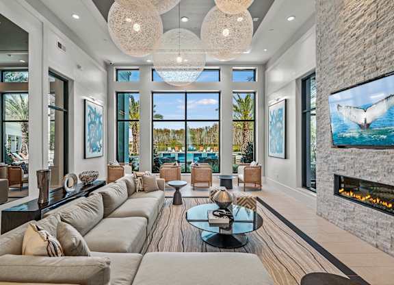 a living room with couches and a view of the ocean  at Altis Grand Suncoast, Land O' Lakes, 34638