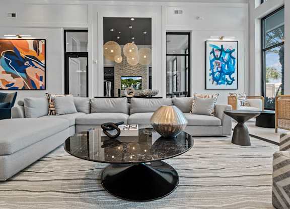 a living room with couches and a table at Altis Twin Lakes Apartments, Florida
