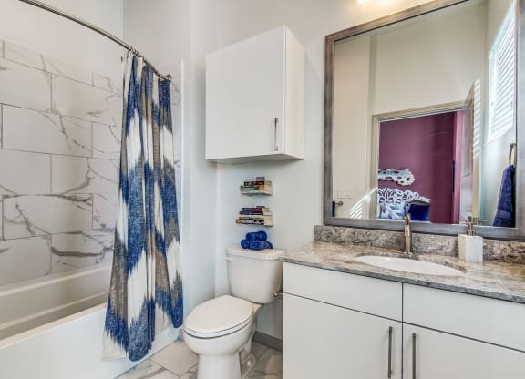 Apartments for Rent Lewisville - Hebron 121 Station - Bathroom With Tile Flooring, Cabinets, and a Modern Shower
