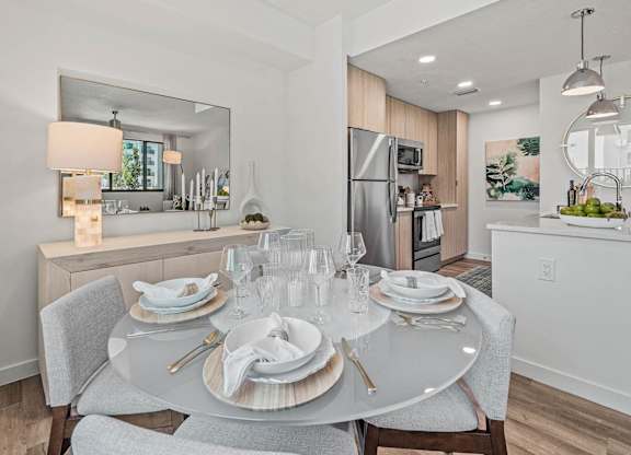 a dining room table with plates and chairs at Altis Santa Barbara, Florida
