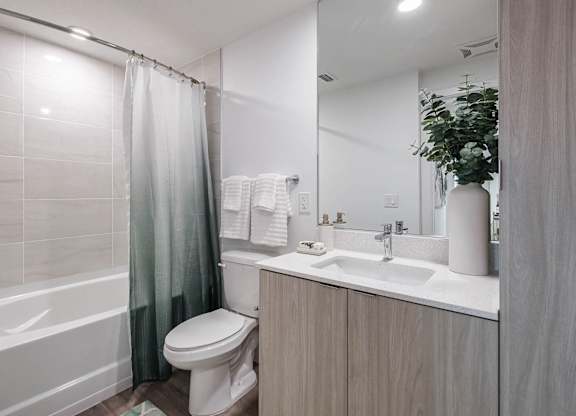 a bathroom with a shower toilet and sink at Altis Santa Barbara, Naples, 34104