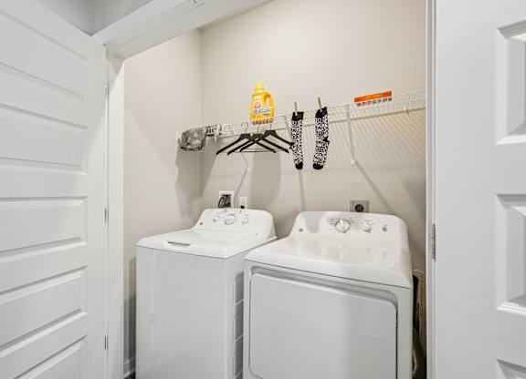 A small laundry room with a washer and dryer.