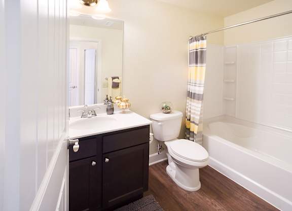 A white toilet sits next to a sink in a bathroom.