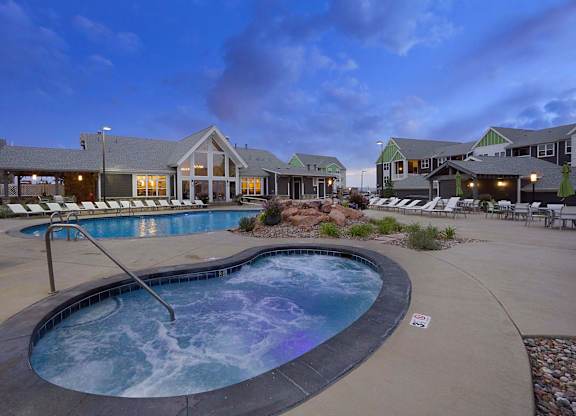 A hot tub sits in the middle of a patio area.