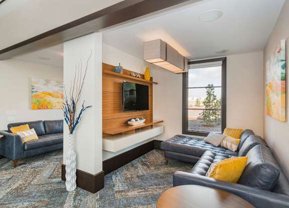 A living room with a blue couch and a television.