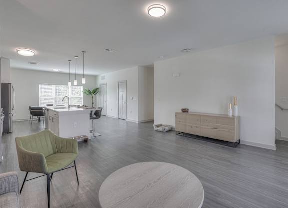 A modern living room with a green chair and a wooden coffee table.