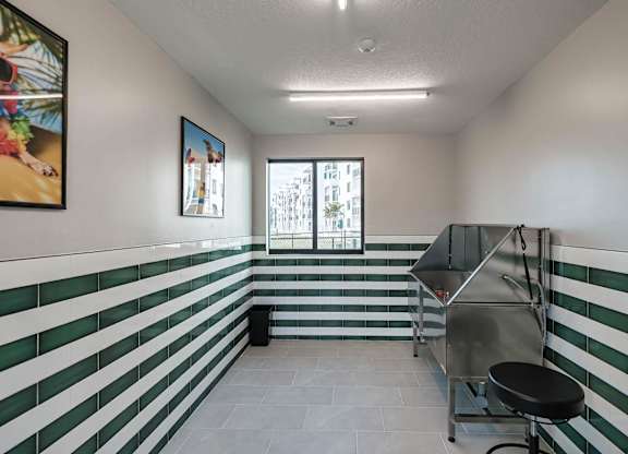 the interior of a room with green and white stripes on the wall and a cart at Altis Santa Barbara, Naples, Florida