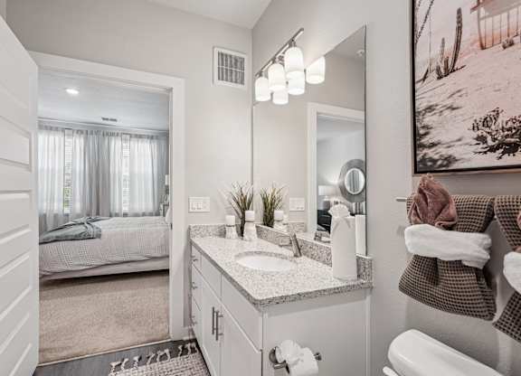 A bathroom with a white sink and a mirror.