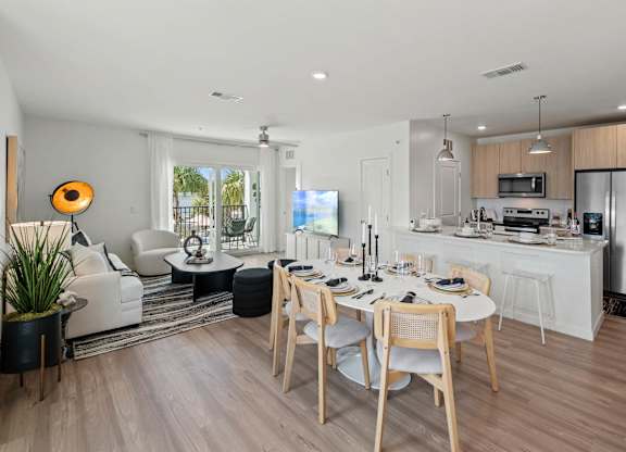 a kitchen and dining room with a table and chairsat Altis Grand Suncoast, Land O' Lakes Florida