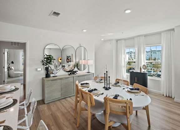 a dining room and living room with a table and chairs at Altis Twin Lakes Apartments, Kissimmee, 34744