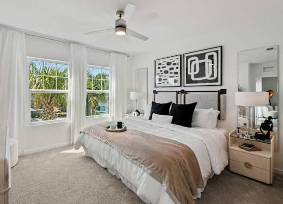 a bedroom with a bed and a ceiling fan at Altis Twin Lakes Apartments, Kissimmee, FL
