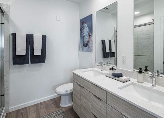 a bathroom with two sinks and a shower and a toilet at Altis Grand Lake Willis, Florida