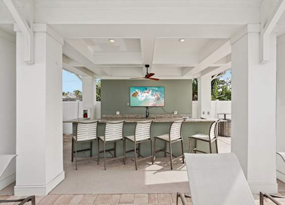 A white patio with a table and chairs.