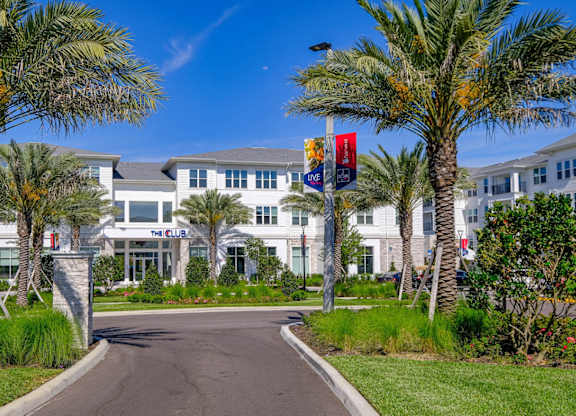 a building with palm trees and a road in front of itat Altis Grand Lake Willis, Orlando, 32821