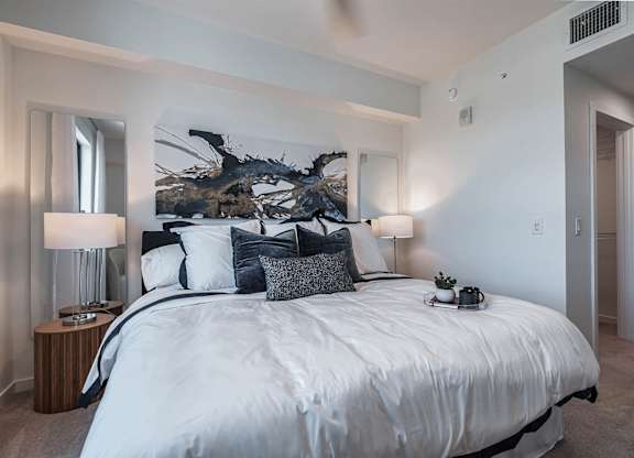 a bedroom with a large bed and a large window at Altis Santa Barbara, Naples, Florida