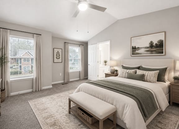 A bedroom with a large bed and a window with curtains.