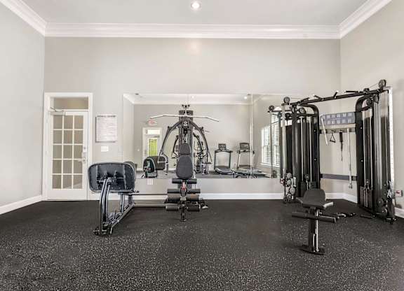A spacious home gym with a variety of equipment.