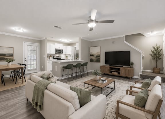 A well-lit living room with a couch, chairs, and a television.
