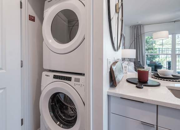 a white washer and dryer in a white laundry room at Altis Grand Lake Willis, Orlando Florida
