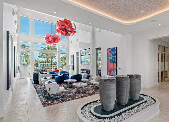 a living room filled with furniture and large windowsat Altis Grand Lake Willis, Orlando, FL