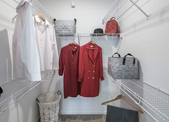 a walk in closet filled with clothes and bags at Altis Grand Lake Willis, Orlando, FL