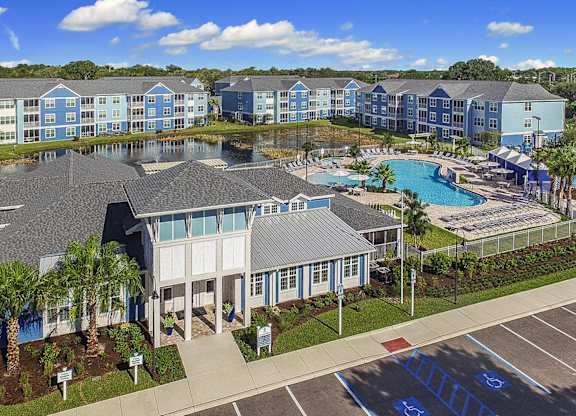 A large building with a pool in front of it.