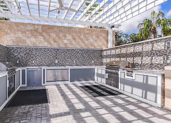 A kitchen with a glass roof and stone walls.