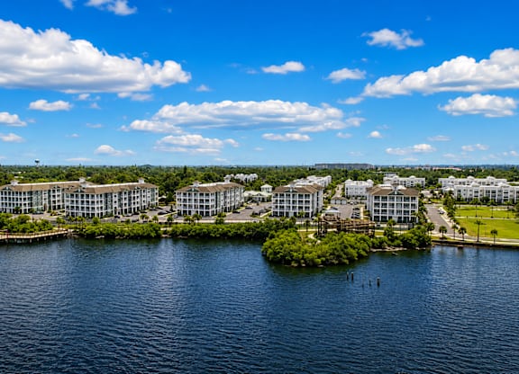 A large body of water with a building complex on the other side.