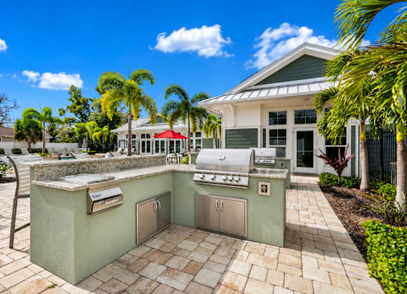 A patio with a built-in grill and barbecue area.