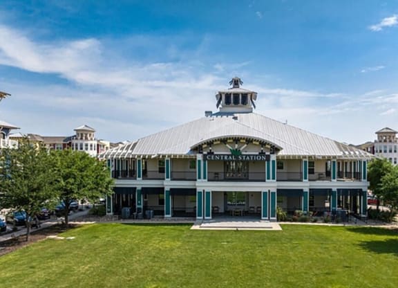 a building with a lawn and trees in front of it