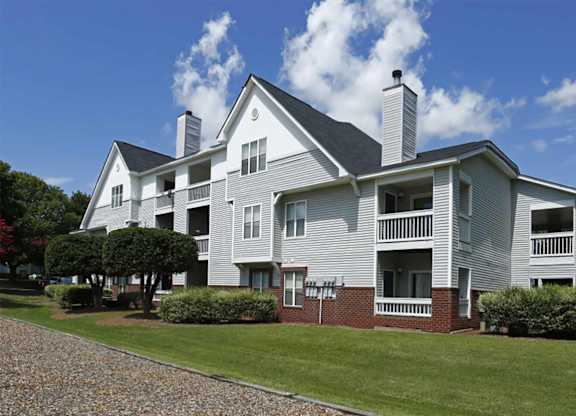A large house with a grey exterior and a balcony.
